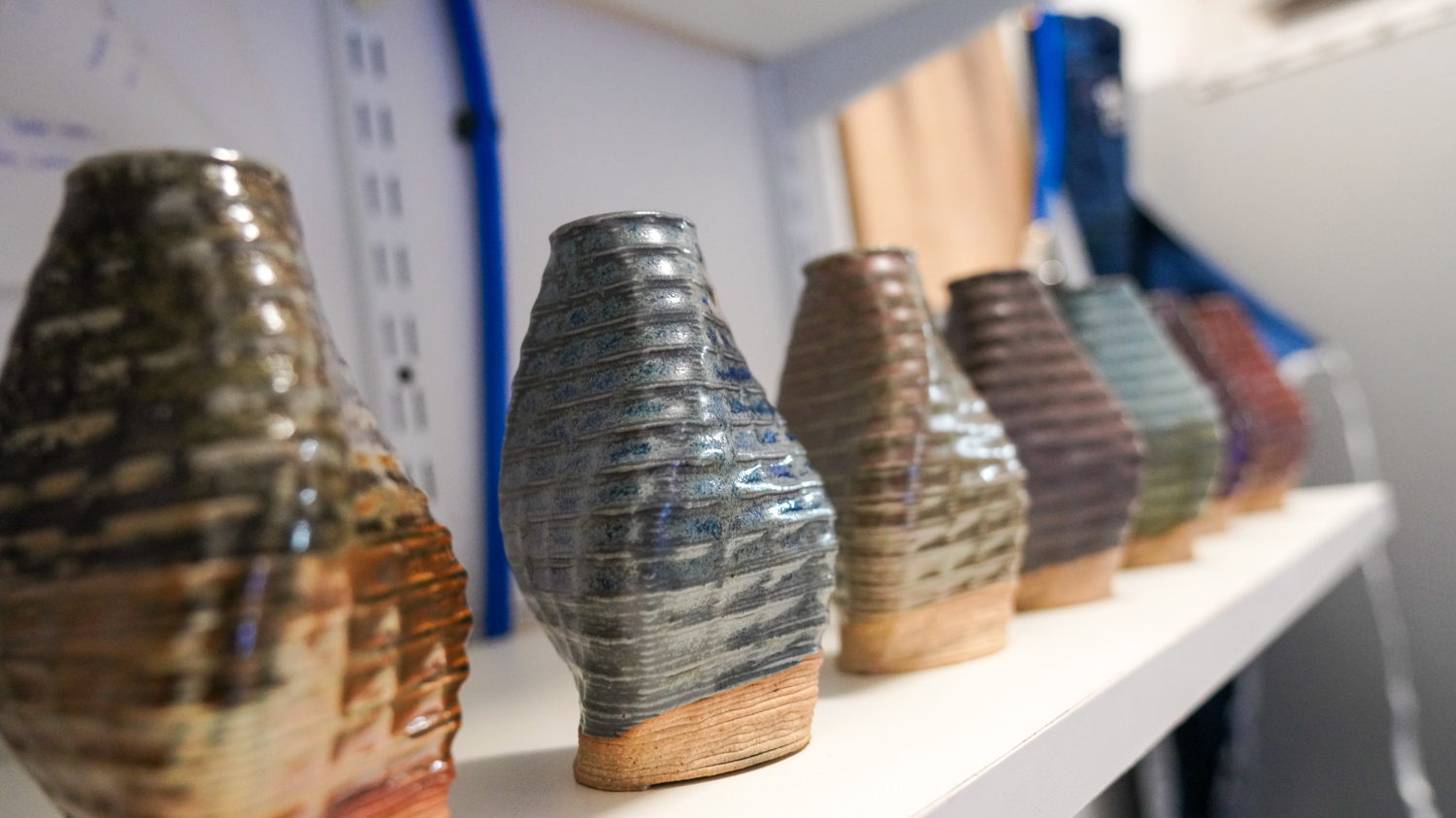 3D-printed ceramic items sit on a shelf in Shawn Protz's ceramics lab