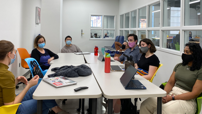 Group of seven students meeting at a conference table during Design it Forwardclass