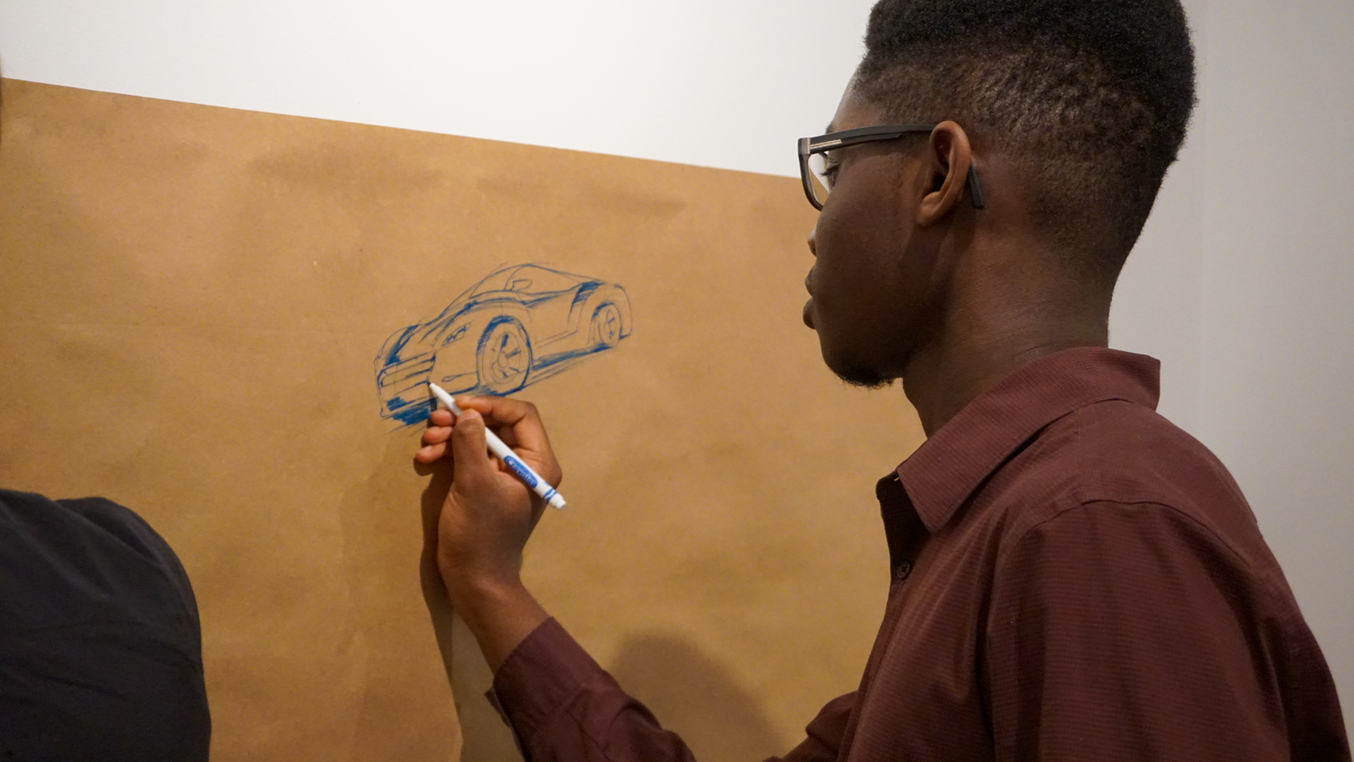 student drawing car
