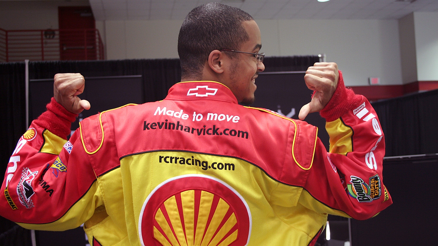 Sean Coleman showing the back of his racing jacket with a Shell logo.