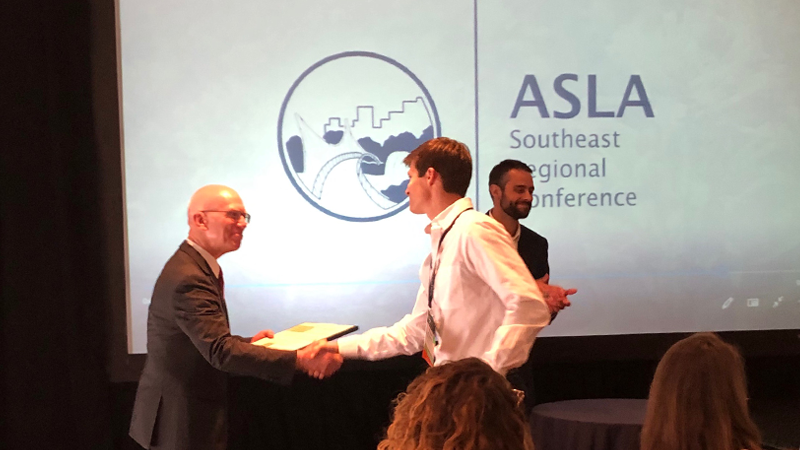 Travis Klondike accepting an award at the 2019 ASLA SER Conference