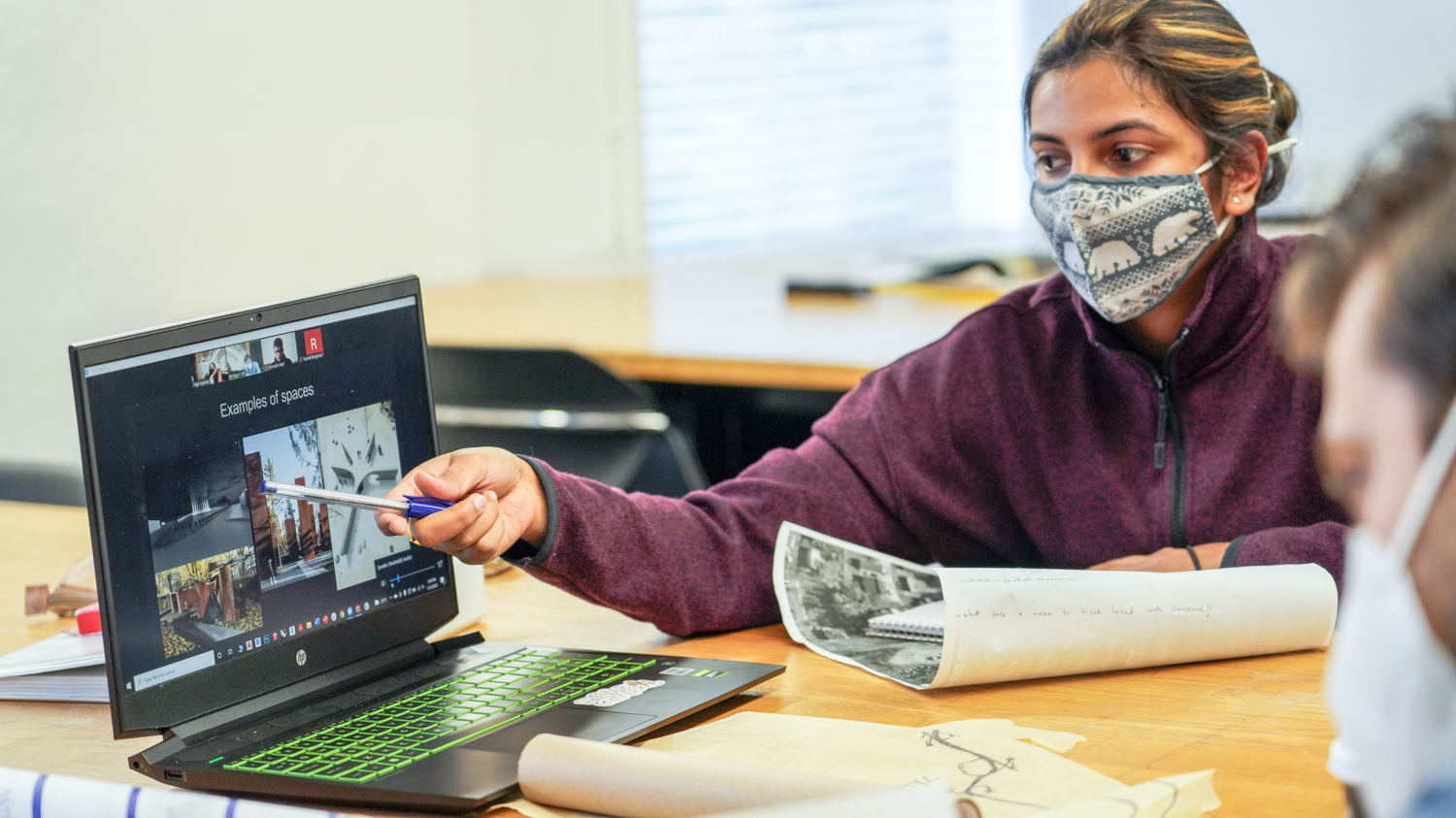 Student pointing at laptop in the Duda Visiting Designer Program