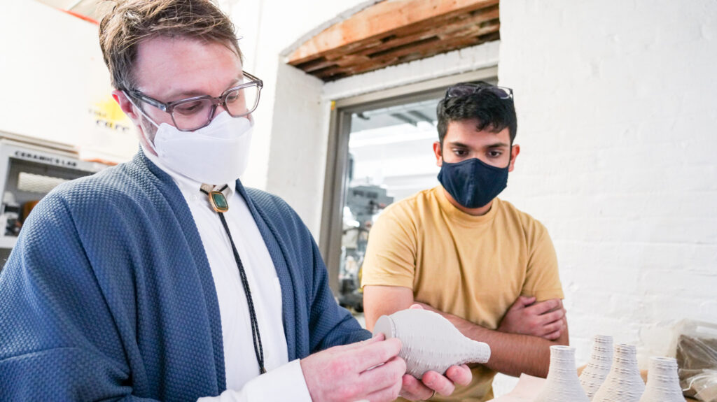 Protz and Shah examine a dried piece before glazing.