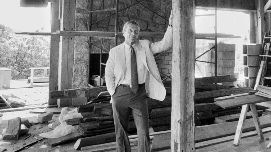 Harry Bates in 1988 inside a home under construction in Water Mill, N.Y., on Long Island. Designed by his firm at the time, Bates & Booher, it incorporated wooden beams from an old barn.