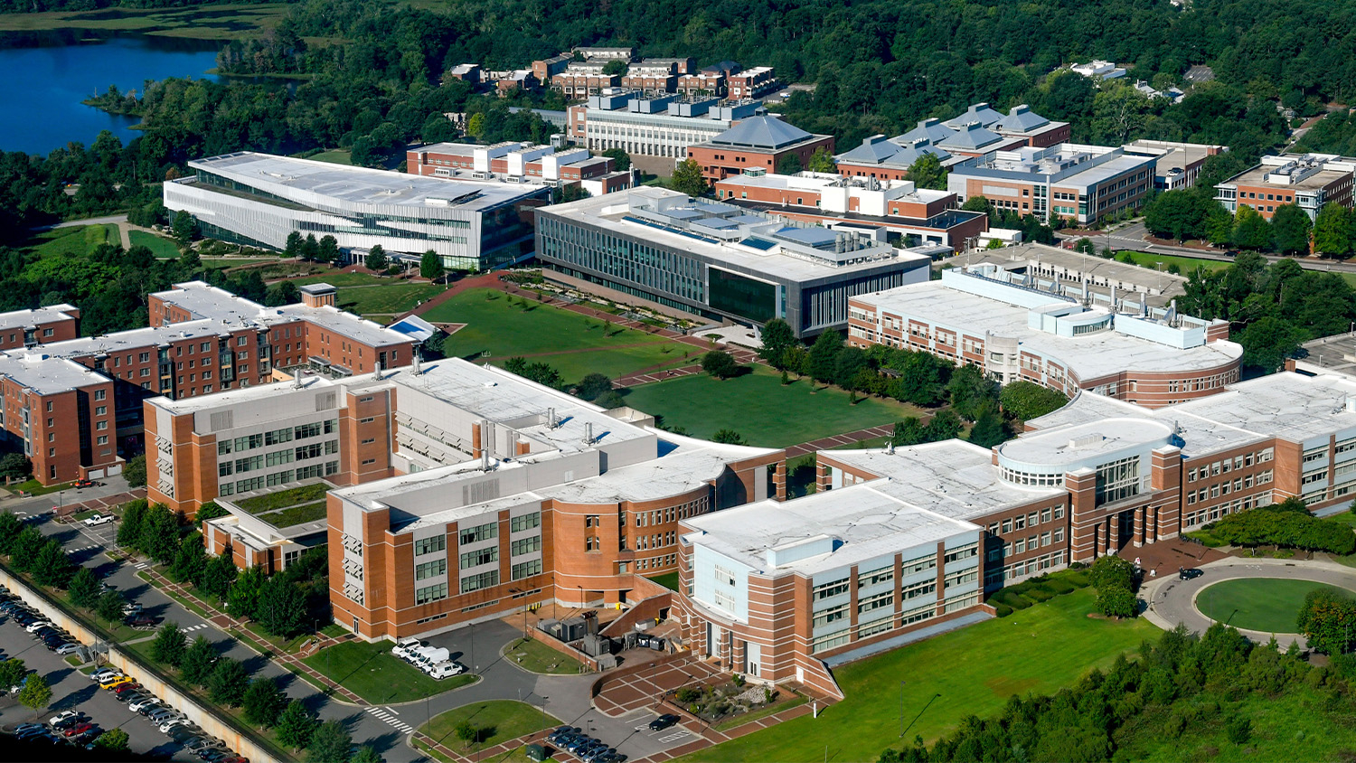 Aerial view of Centennial Campus, with the oval-shaped green space in the middle of a block of buildings