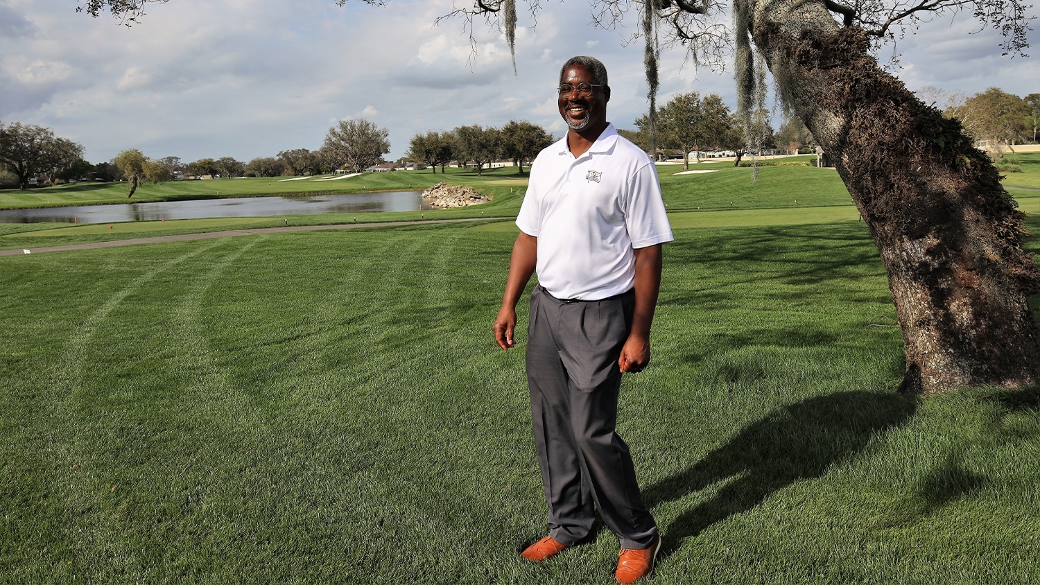 Brandon Johnson standing on the green of Arnold Palmer's Bay Hill Golf Course.