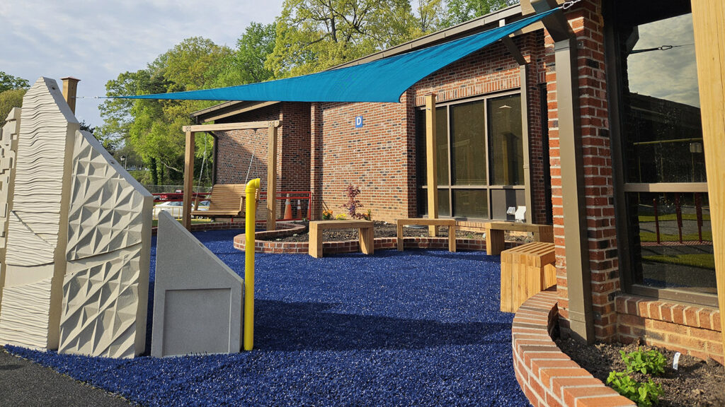 Governor Morehead School Outdoor Accessibility Center. Photo shows shade sails and bench seating.
