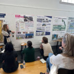 A student presents their project for Paper Streets.