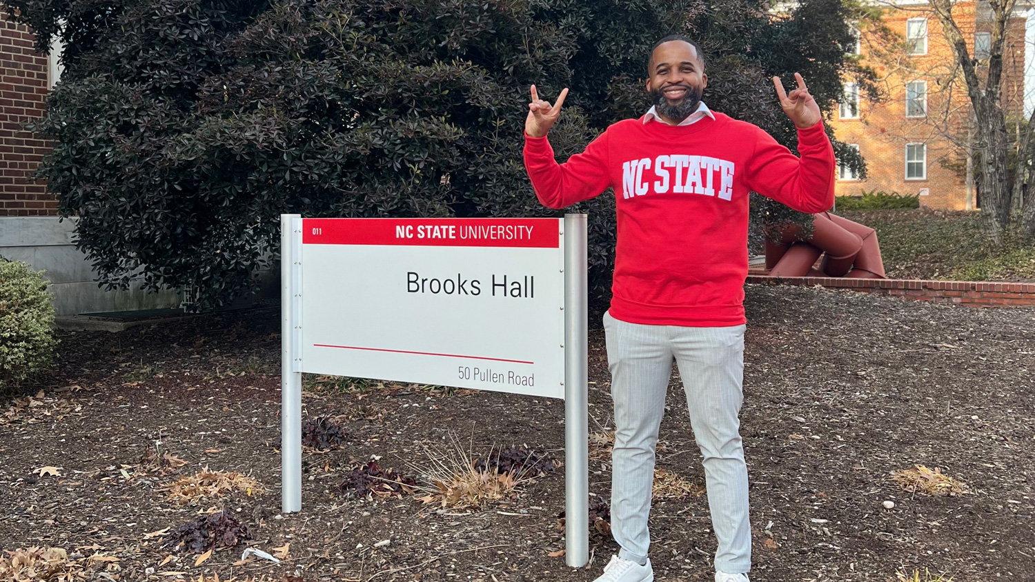 Demarcus Williams with College of Design Brooks Hall sign