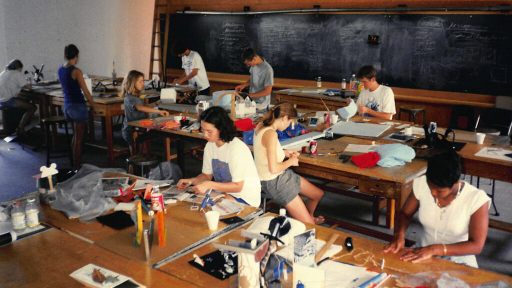 A photo from 1997 shows campers creating in much the same way they do today — at studio tables in a collaborative environment.