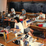 A photo from 1997 shows campers creating in much the same way they do today — at studio tables in a collaborative environment.