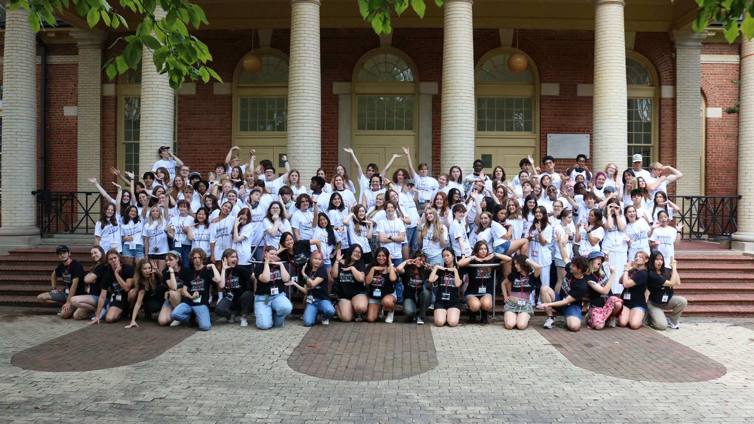 Students from Design Camp 2024 celebrate another year of successful programming. Campers are pictured in white t-shirts, while support staff wear black in the first row.