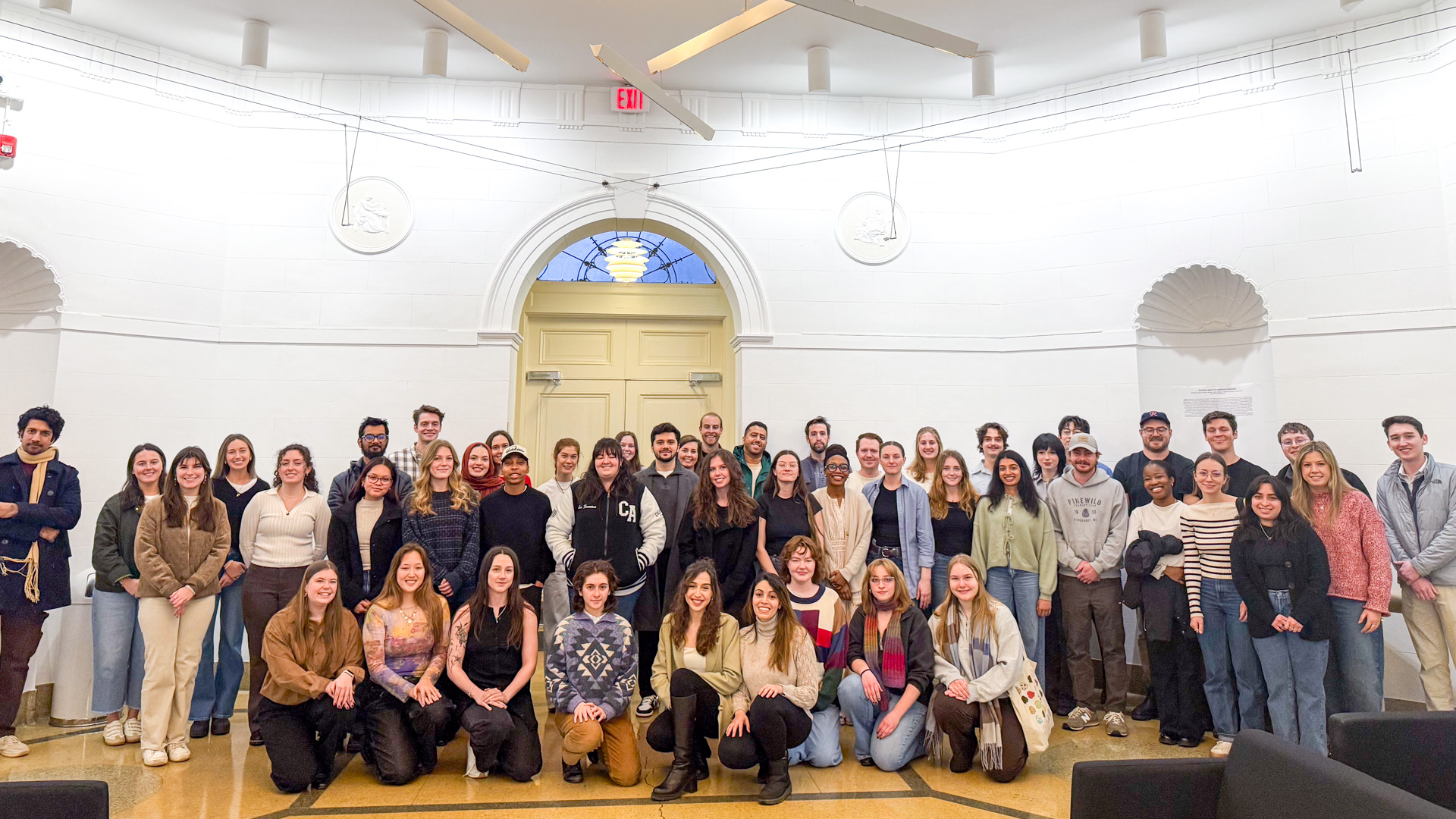 Group of architecture students posing together in the Brooks Hall Lobby.