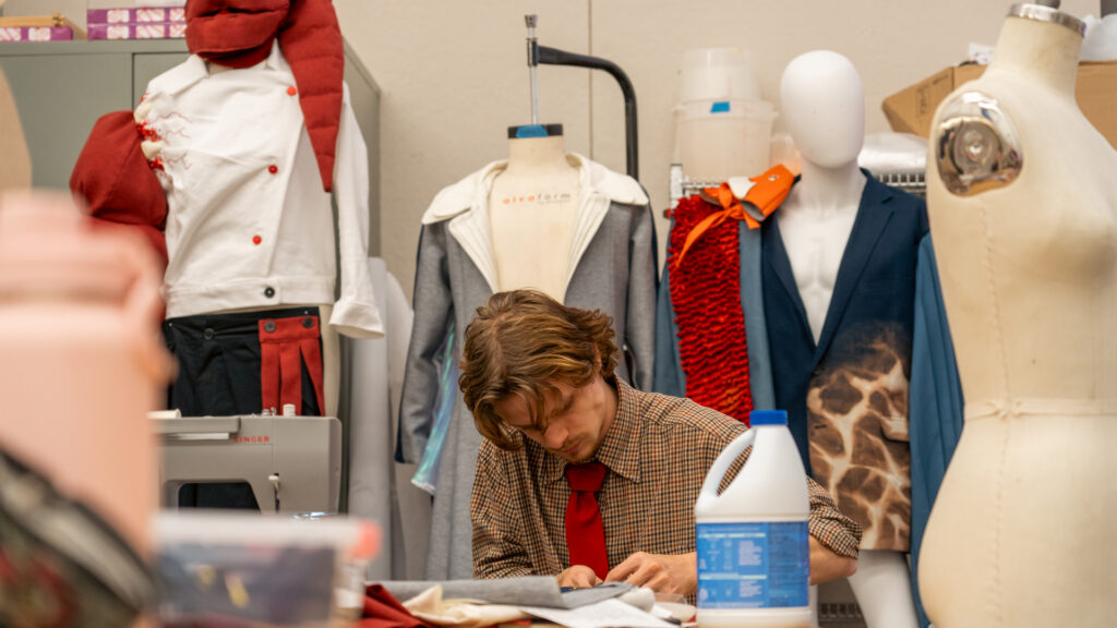 Student Henry O'Bryan working on stitching his collection titled Mimiosis in the Art2Wear studio.