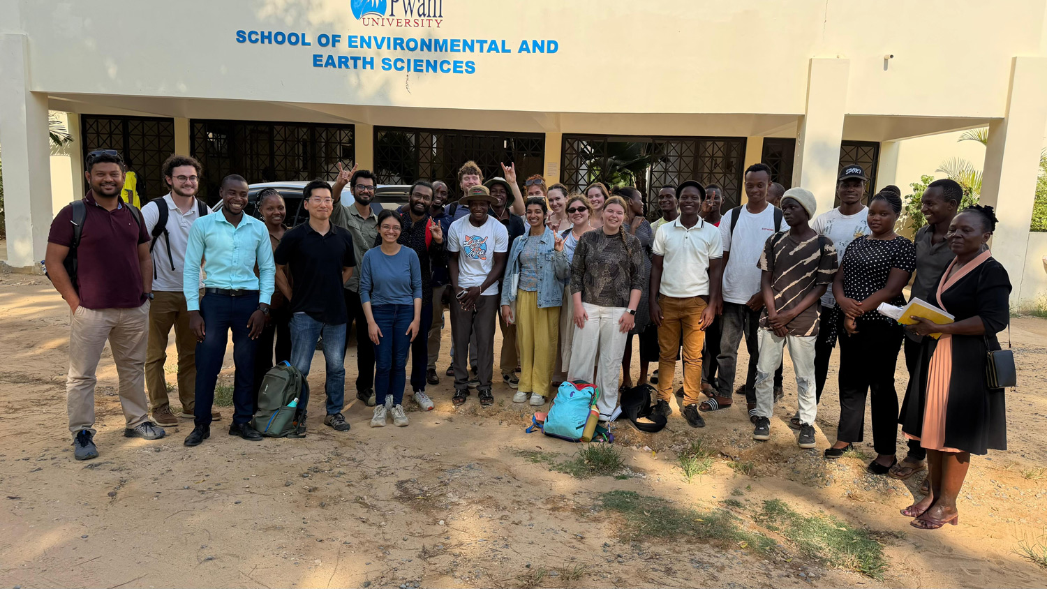 Group poses with members of Pwani University.