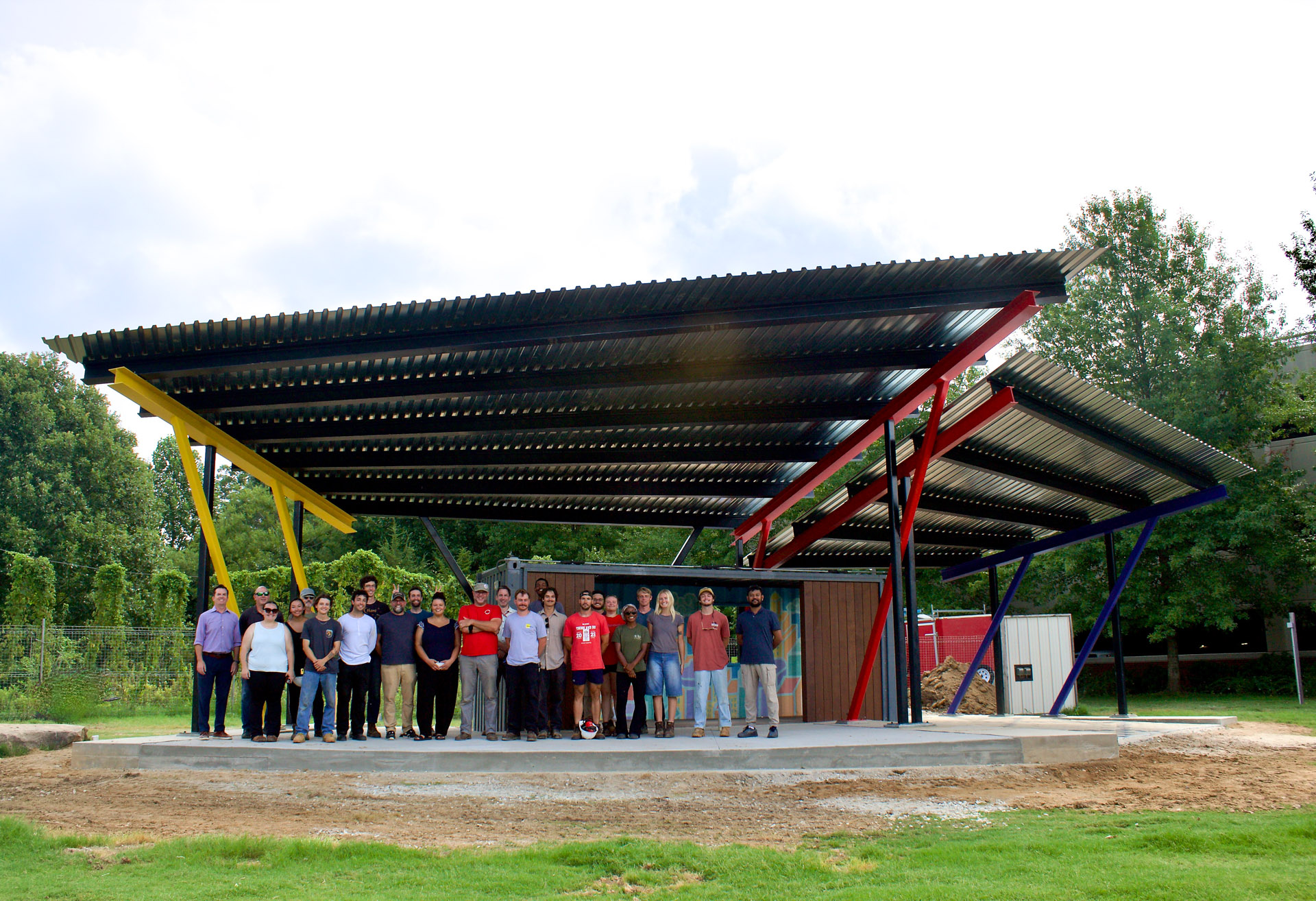 Group photo in front of structure